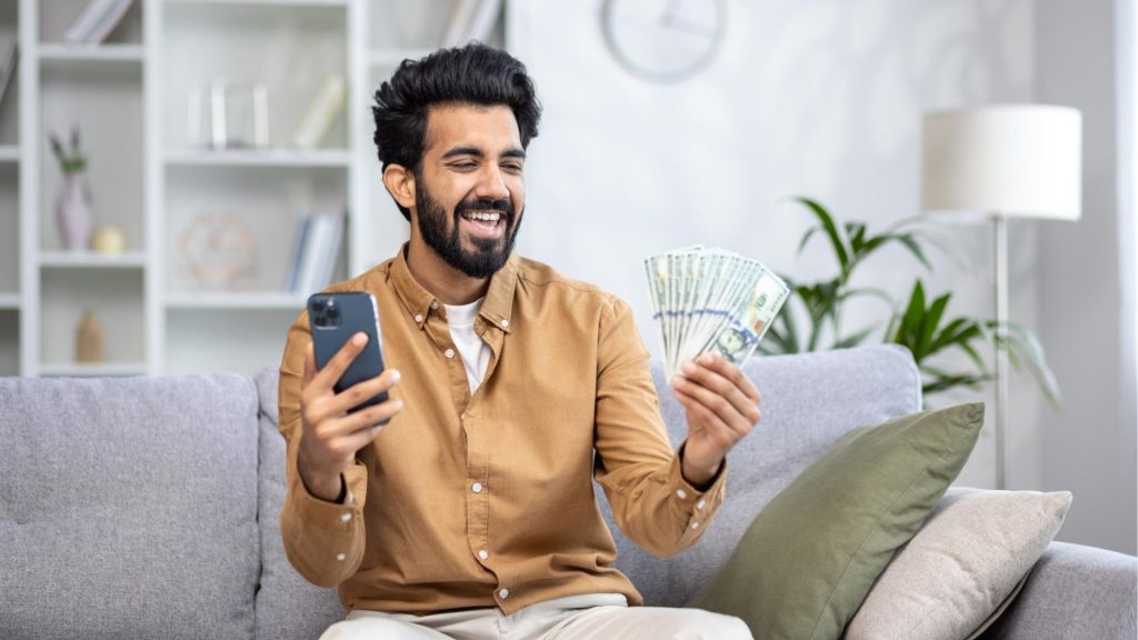 Person using a smartphone with digital money icons, illustrating ways to earn money online.