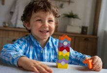 Child arranging colorful number blocks