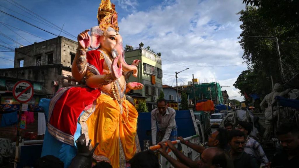 People carry Lord Ganesha idol in Kolkata during Ganesh Chaturthi 2025.